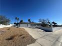 Ranch style home with a three-car garage and gravel landscaping at 6510 Viewpoint Dr, Las Vegas, NV 89156