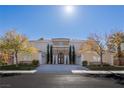 Elegant two-story home featuring a neutral color scheme and lush landscaping at 8109 Dark Hollow Pl, Las Vegas, NV 89117