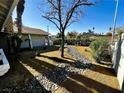 Landscaped front yard with a rock pathway and mature trees at , Las Vegas, NV 89121