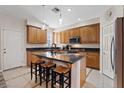 Modern kitchen features a center island and light wood cabinets at 11356 Belmont Lake Dr # 103, Las Vegas, NV 89135