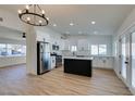 Modern kitchen featuring white shaker cabinets, quartz countertops, and stainless steel appliances at 5610 Surrey St, Las Vegas, NV 89119