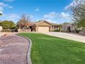 Single story home with a landscaped yard and driveway at 570 Long Iron Ln, Mesquite, NV 89027