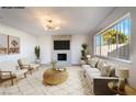 Virtually staged living room features a fireplace and large windows at 4450 San Rafael Ave, Las Vegas, NV 89120