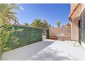 Private patio area with artificial turf wall and gate access at 5457 Escondido St, Las Vegas, NV 89119