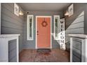 Modern front door with welcome sign and sidelights at 6290 Craigmont Ave, Las Vegas, NV 89103