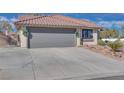 Gray garage door and driveway of a single-story house at 188 Beach Oak Ave, Henderson, NV 89002