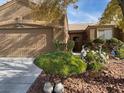 Well-maintained house with attractive landscaping and a large front yard at 6138 Glamorous Ct, North Las Vegas, NV 89031