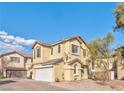 Two-story house with a white garage door, satellite dish, and desert landscaping at 1966 Sunset Bend Dr, Henderson, NV 89014