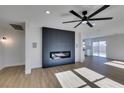 Bright living room with fireplace, hardwood floors, and ceiling fan at 8412 Wildheart Ranch St, Las Vegas, NV 89131