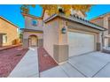 Two-story house with beige exterior and attached garage at 6512 Copper Smith Ct, North Las Vegas, NV 89084