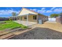 Covered patio, grassy area, and gravel landscaping in the backyard at 6543 Stormy Sky Ave, Las Vegas, NV 89110