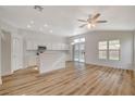 Open concept kitchen with white cabinets and wood flooring at 6543 Stormy Sky Ave, Las Vegas, NV 89110