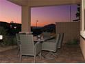 Covered patio with seating area, brick flooring, and mountain views at 744 Dorsey Falls St, Henderson, NV 89011