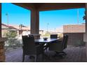 Covered patio with seating area and mountain views in daytime at 744 Dorsey Falls St, Henderson, NV 89011