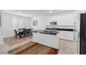 Modern kitchen with island, stainless steel appliances, and white cabinets at 2970 Gunnery Forge St, Las Vegas, NV 89156