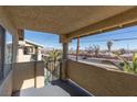 Balcony view with partial street and distant mountain view at 304 S Buffalo Dr # 201, Las Vegas, NV 89145