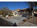 Front view of house, two-car garage, and driveway at 11076 Zampino St, Las Vegas, NV 89141