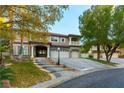 Two-story house with a three-car garage and landscaped yard at 2416 Legacy Island Cir, Henderson, NV 89074