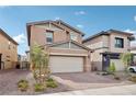 Two-story house with beige siding, gray accents, and a two-car garage at 427 Blue Lark Dr, Henderson, NV 89011