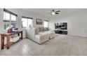 Spacious living room featuring a comfortable sectional sofa and large windows at 4479 Stardust Moon Ave, North Las Vegas, NV 89084