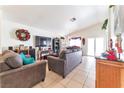 Bright living room, featuring a TV, comfortable seating and dining area at 4601 Skybolt St, Las Vegas, NV 89115