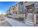 Modern townhouse with gray exterior, private stairs and landscaping at 11576 Ashy Storm Ave, Las Vegas, NV 89138