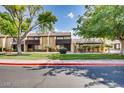 View of townhouses with a red curb and green landscaping at 3358 China Dr, Las Vegas, NV 89121