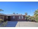 View of the home's side, showcasing solar panels and desert landscaping at 4055 Syracuse Dr, Las Vegas, NV 89121