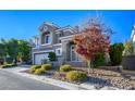 Two-story house with gray exterior, landscaping, and a two-car garage at 925 Siena Hills Ln, Las Vegas, NV 89144