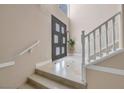 Bright entryway with double doors and staircase with white railing at 2209 Purple Majesty Ct, Las Vegas, NV 89117