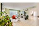 Bright living room with orange accent chair and large TV at 27 Sirnoble St, Las Vegas, NV 89110