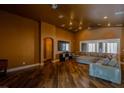 Spacious living room with wood-look flooring, large sectional sofa, and recessed lighting at 3508 Pantego Ave, North Las Vegas, NV 89031