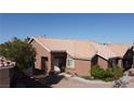 Brown stucco house with tile roof, viewed from the side at 5900 Ablette Ave, Las Vegas, NV 89122