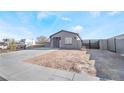 New single-story house with gray exterior, gated driveway, and landscaped yard at 60 Pecos St, Las Vegas, NV 89110