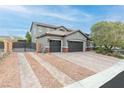 Two-story house with a three-car garage and gated driveway at 7306 Puckershire St, Las Vegas, NV 89166