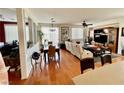 Bright, open living and dining area with wood floors, ceiling fan and built-in entertainment center at 7462 Cleghorn Canyon Way, Las Vegas, NV 89113