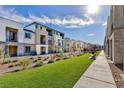 Landscaped walking path with a bench in front of townhomes at 6163 Garden Oasis St, Las Vegas, NV 89148