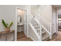 A bright entryway with a staircase and powder room at 391 American Dipper St, Las Vegas, NV 89138