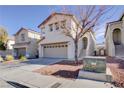 Two story house with attached garage and landscaping at 6608 Wind Whisper St, Las Vegas, NV 89148