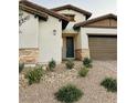 Two-story house with dark brown door and landscaping at 10287 Ansley Bay Ave, Las Vegas, NV 89166