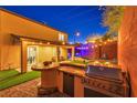 Outdoor kitchen with grill and patio area at 10590 Sturdevant Ct, Las Vegas, NV 89166