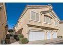 Tan two-story house with a three-car garage at 1628 Clint Canyon Dr, Henderson, NV 89002