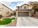 Two story house with artificial turf and stone landscaping at 2456 Rue Bienville Way, Henderson, NV 89044