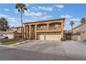 Two-story house with a three-car garage and manicured lawn at 9675 Summer Lilac Ct, Las Vegas, NV 89123