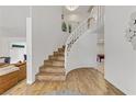 Modern curved staircase with wood steps and white railings at 4330 Flandes St, Las Vegas, NV 89121