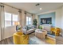 Cozy living room with a stylish coffee table and accent chairs at 7830 Pandora Sky St # 192, Las Vegas, NV 89084