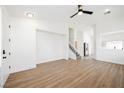 Bright and airy living room with light hardwood floors and a view of the kitchen and staircase at 886 Park Walk Ave, Las Vegas, NV 89123