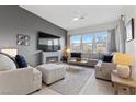 Bright and airy living room featuring a fireplace and ample seating at 9876 Cullin Range Ave, Las Vegas, NV 89166