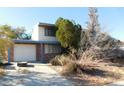 Two-story house with attached garage and mature landscaping at 209 Catalini St, Las Vegas, NV 89107