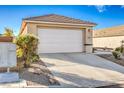 Attached two-car garage with a white door at 2409 Sturrock Dr, Henderson, NV 89044